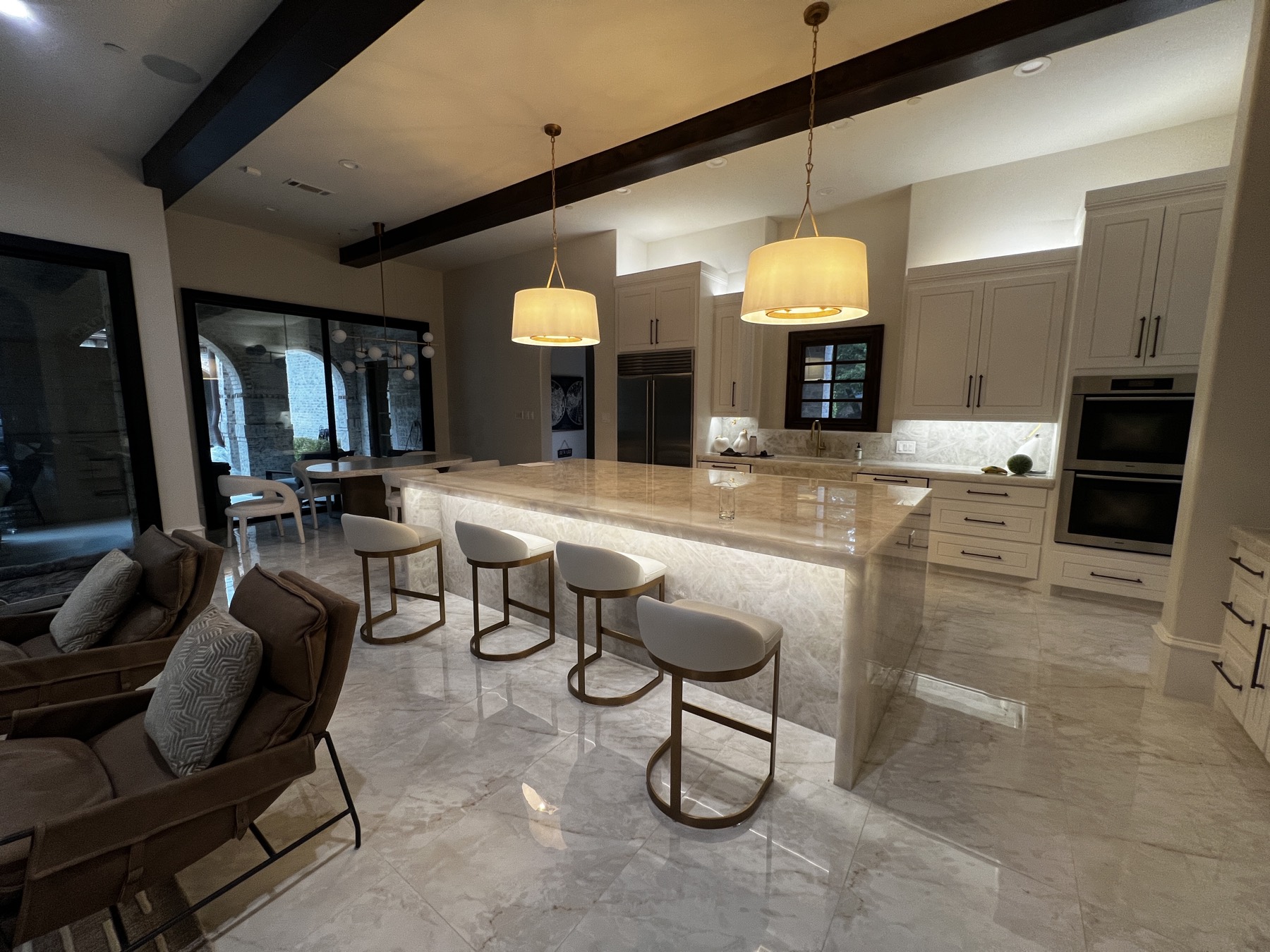 Kitchen with backlit quartzite island and above-cabinet LED glow